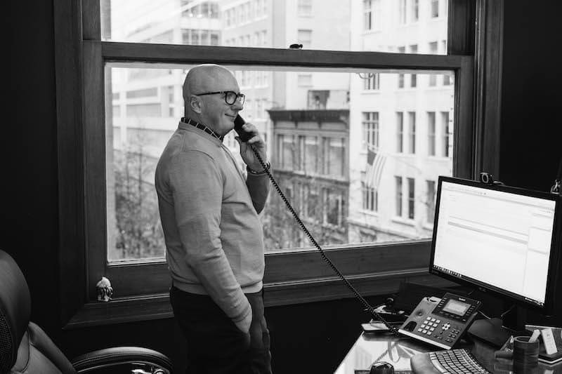 Attorney Jim Dwyer stands while speaking on the phone at his Bridge City Law office