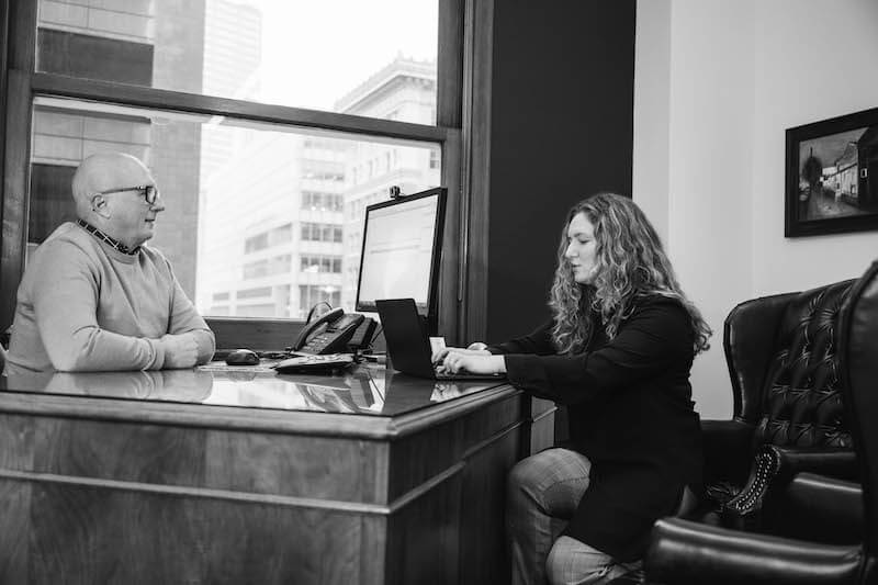 Personal injury lawyer Jim Dwyer and legal assistant Savannah Lee discuss legal matters at Bridge City Law